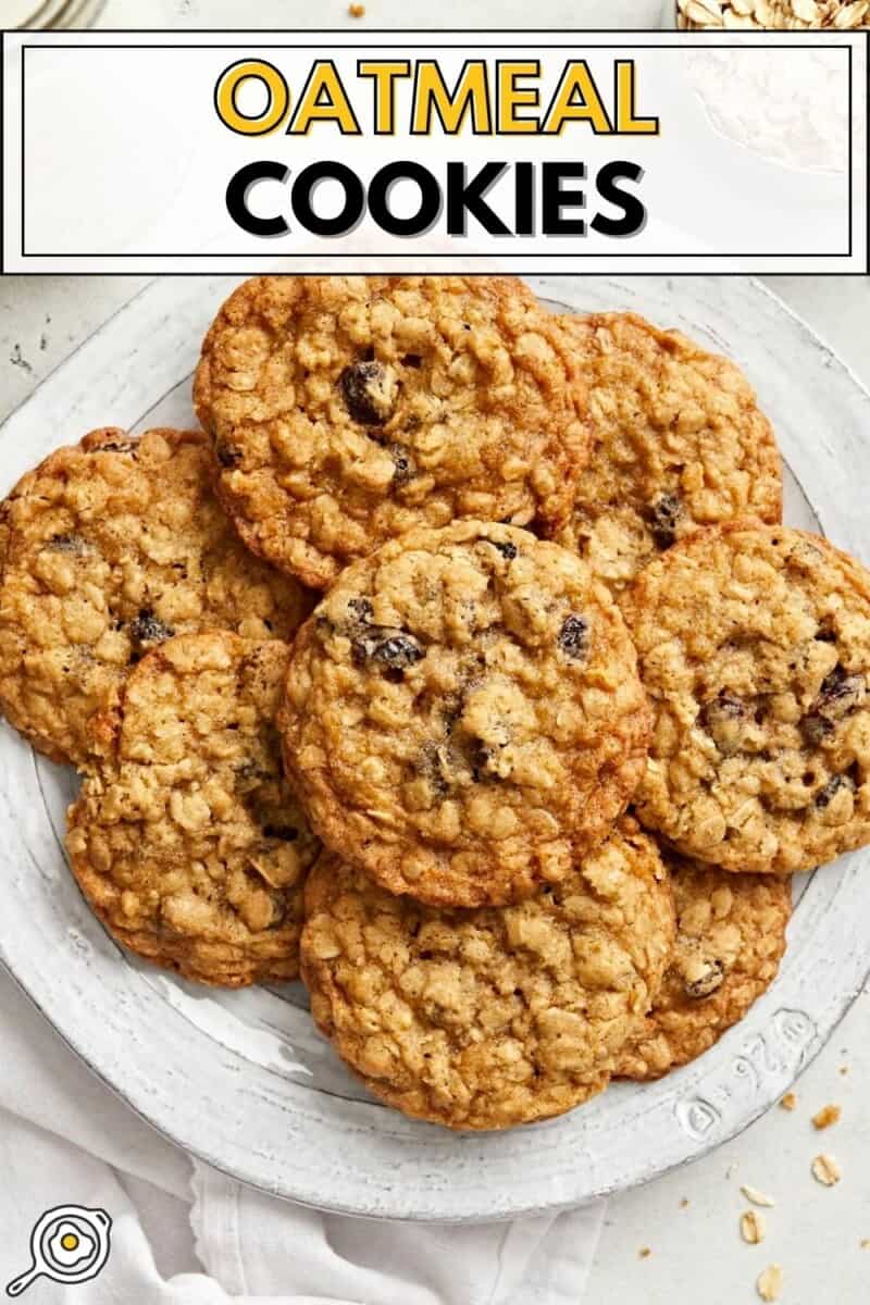 Overhead view of a pile of oatmeal cookies on a plate with title text at the top.