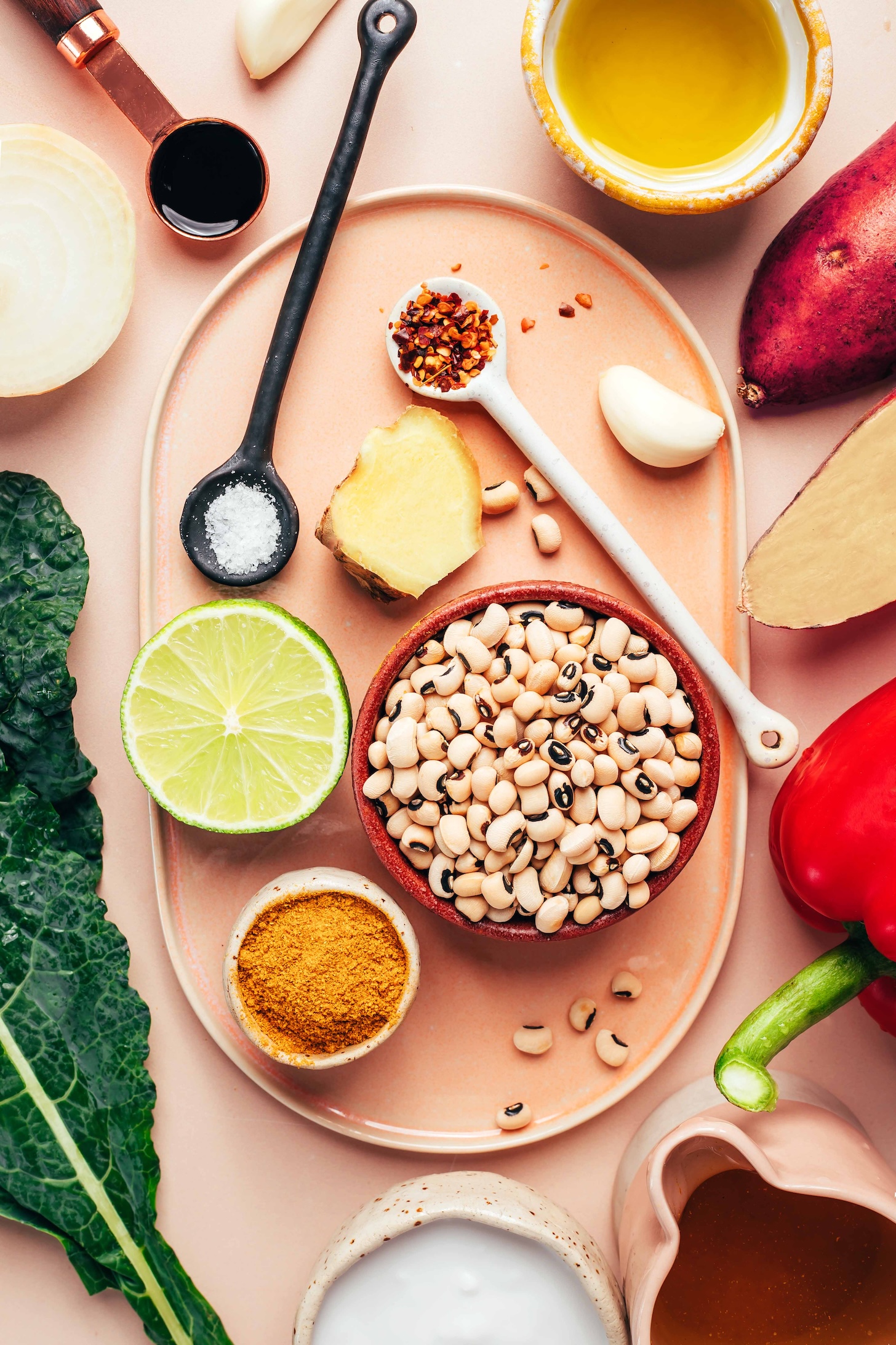 Oil, sweet potato, red bell pepper, broth, coconut milk, curry powder, kale, black eyed peas, lime, ginger, garlic, red pepper flakes, salt, onion, and coconut aminos