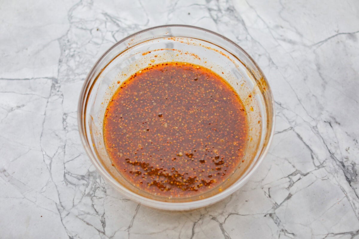 Honey mustard sauce ingredients all mixed together in a bowl.