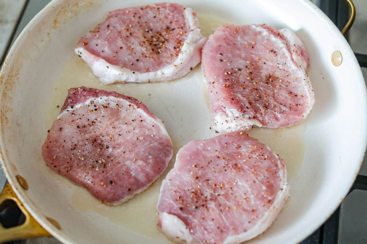 Chops in a skillet with heated olive oil.