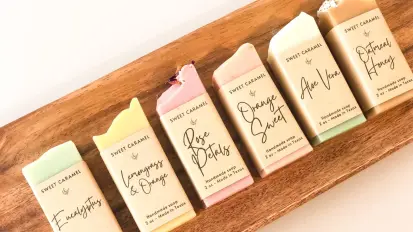 Hand soaps with paper labels arranged on wooden tray