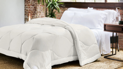 Buffy Cloud Comforter on bed in bedroom with brick wall