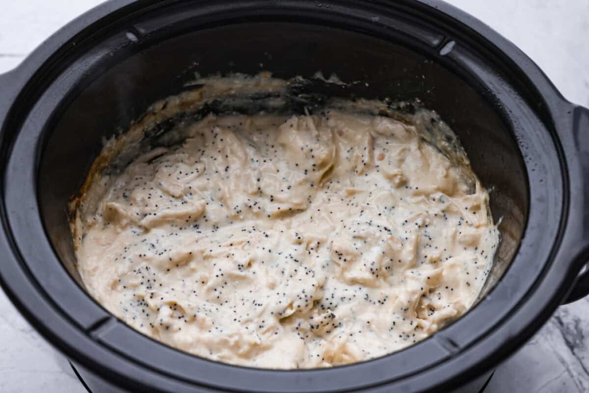 If you love my classic poppyseed chicken casserole, this crockpot poppyseed chicken is the easiest way to make it. Same creamy, buttery flavor. Same cozy comfort. Cooked chicken shredded and poppyseeds added to the crockpot.