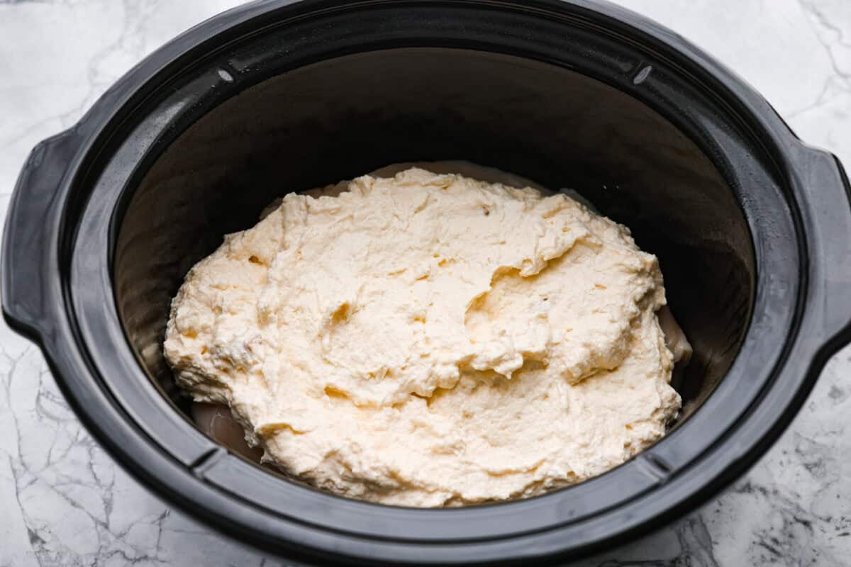 If you love my classic poppyseed chicken casserole, this crockpot poppyseed chicken is the easiest way to make it. Same creamy, buttery flavor. Same cozy comfort. Soup and sour cream mixture added to the top of the chicken.