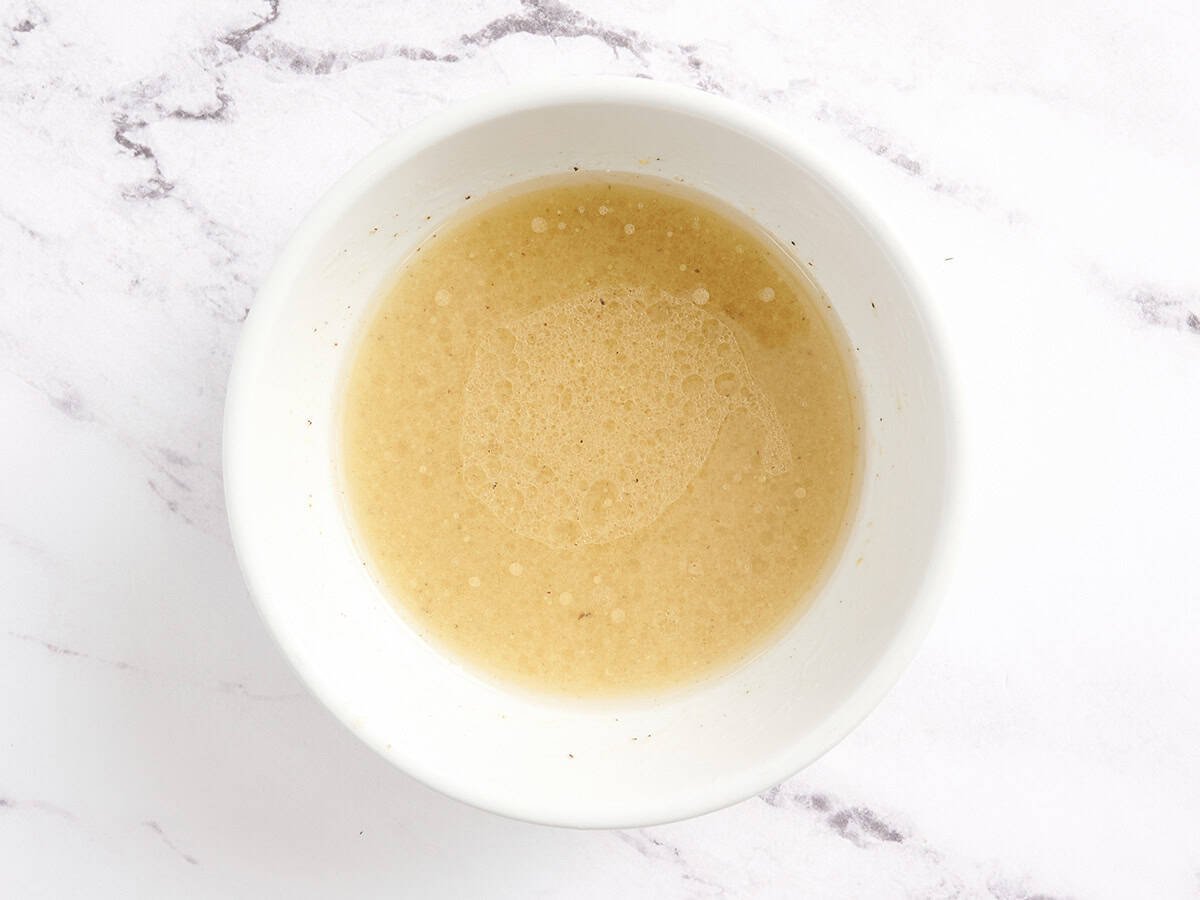 Finished vinaigrette in a bowl.