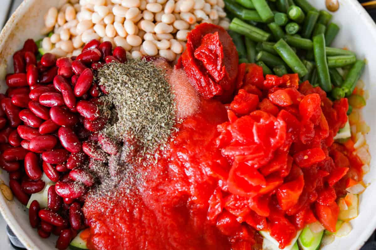 Beans, tomatoes, and seasonings added to the veggies.