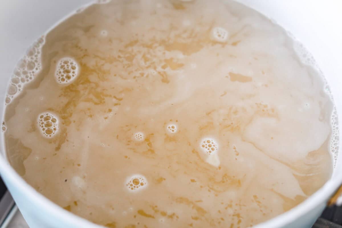 Pot with pasta cooking in boiling water.