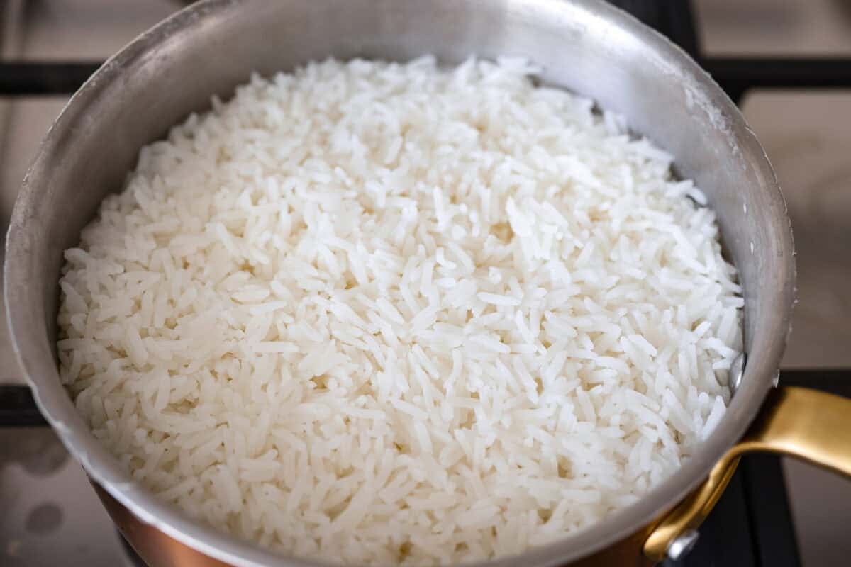 White rice cooking in a pot on the stove.