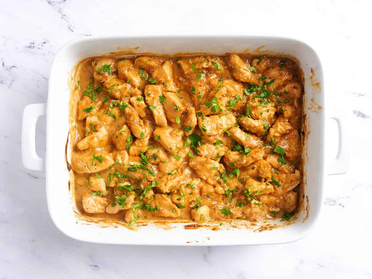 Finished thai peanut chicken in a baking dish.