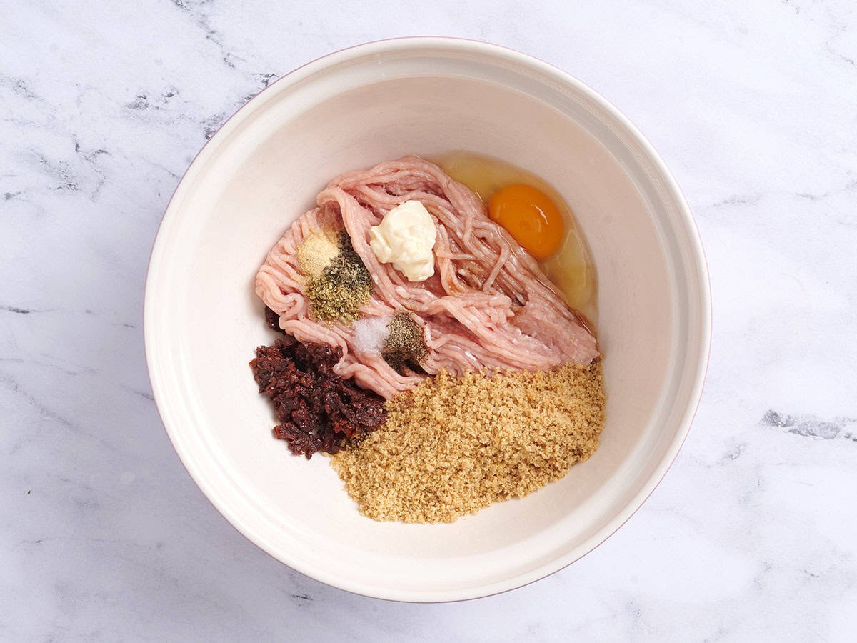Chicken meatball ingredients in a bowl.