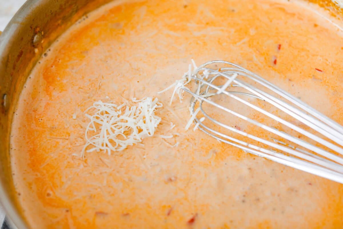 Someone whisking in the cheese