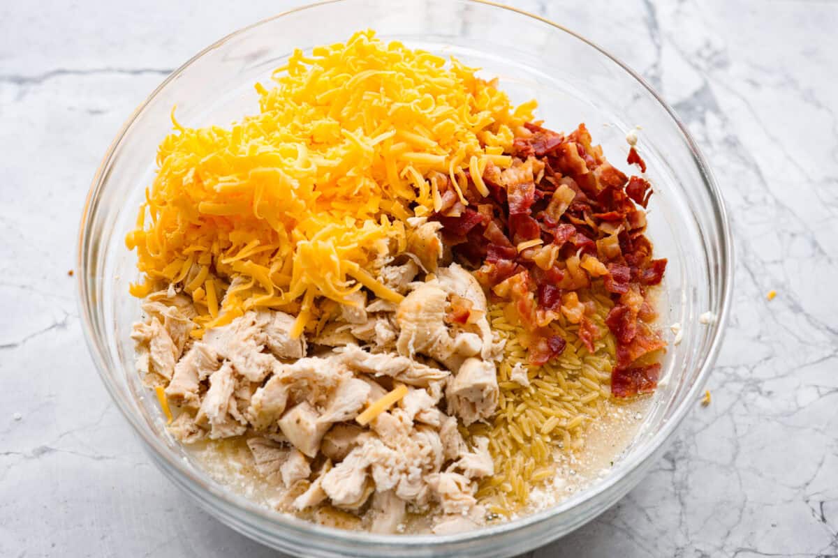 Cheese, chicken, bacon and uncooked orzo added to the bowl.