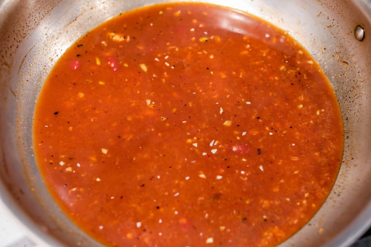 Sauce ingredients added to the pan with the broth.