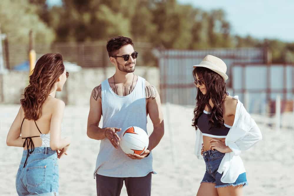 sunglasses for the beach - Best Sunglasses for the Beach (Including Watersports & Volleyball) Friends playing volleyball on the beach