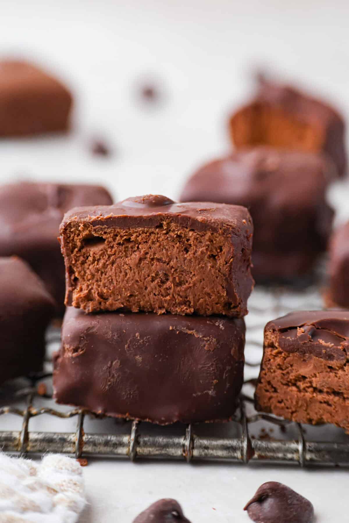 Two pieces of cool whip candy stacked on top of each other and the top one is cut in half.