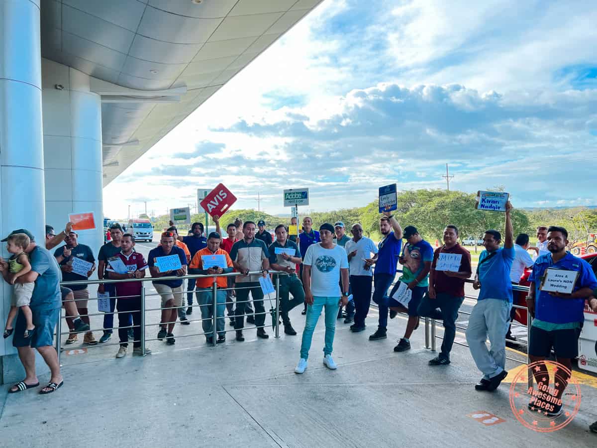 liberia airport car rental pick up staff holding signs