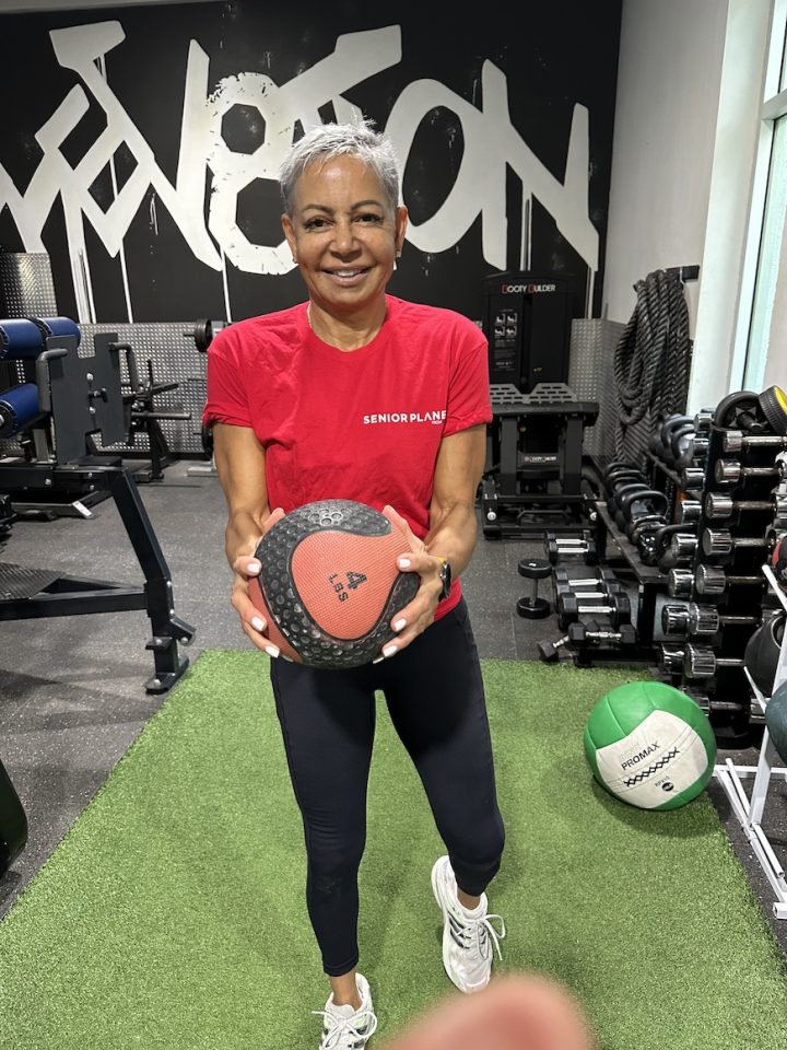 senior woman holding medicine ball