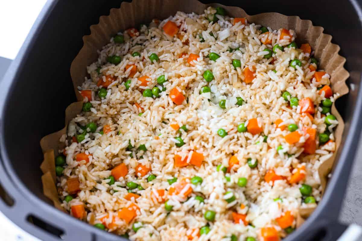 Did you know you can make fried rice in the air fryer? My Air Fryer Fried Rice recipe takes something already simple and makes it even easier. You get golden, slightly crispy rice, tender veggies, and the best flavor with hardly any effort. All of the ingredients stirred together and spread out.