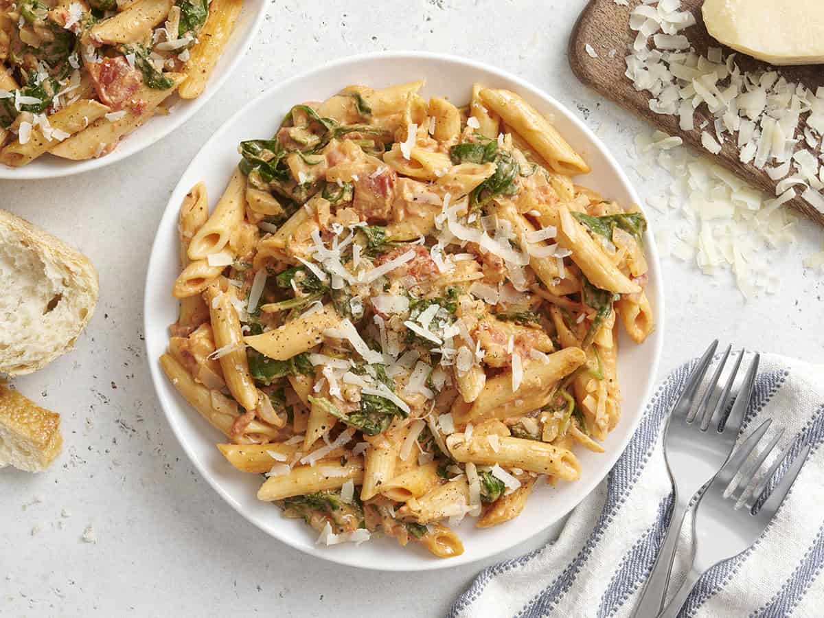 Overhead view of creamy spinach pasta on a plate.