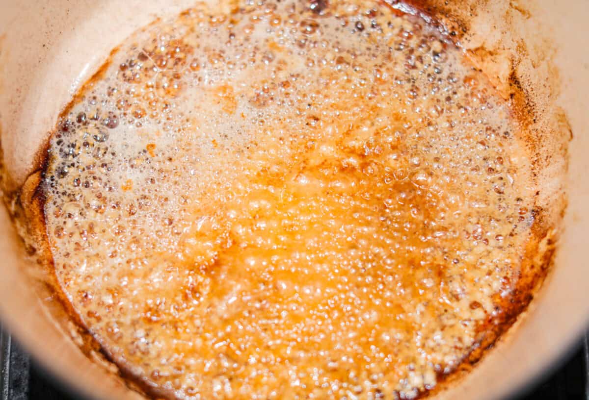 Butter melting in the dutch oven with all of the browned bits from browning the meat.