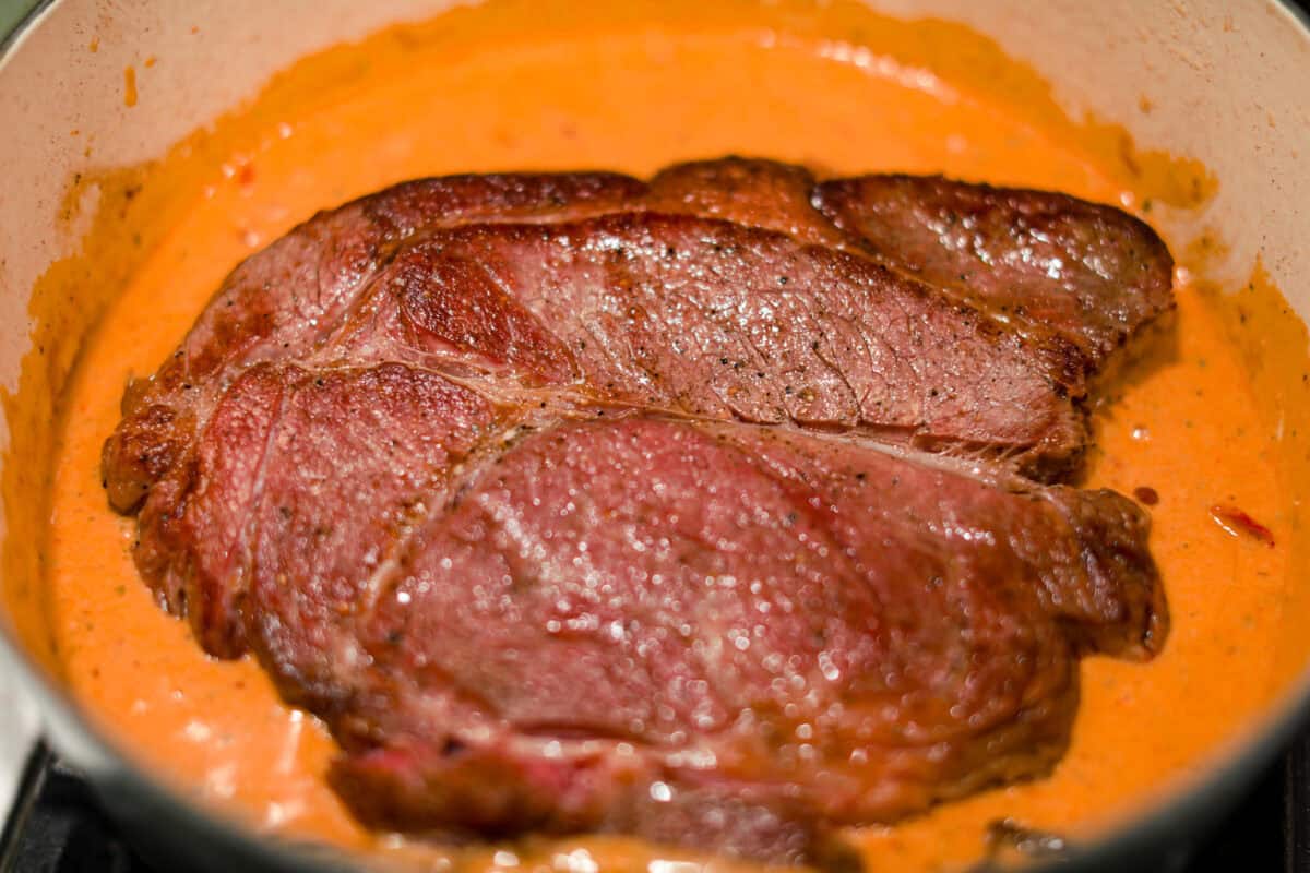 Browned meat added to the sauce and then put it in oven to cook low and slow.