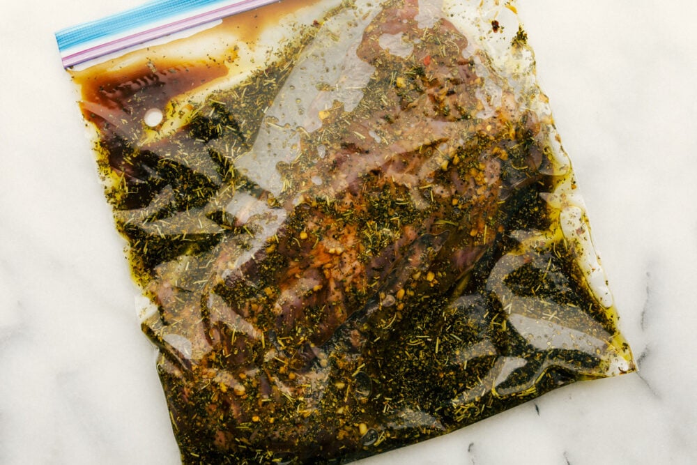 Skirt Steak Marinade is the perfect combination of spices and sauces to create a flavor that really pops! This incredible marinade works for more than just skirt steak too! A ziplock bag of skirt steak marinade.