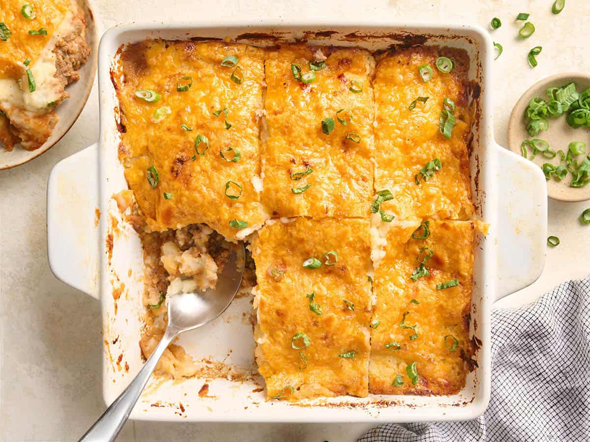 A meatloaf casserole sliced into 6 slices, with a piece missing.