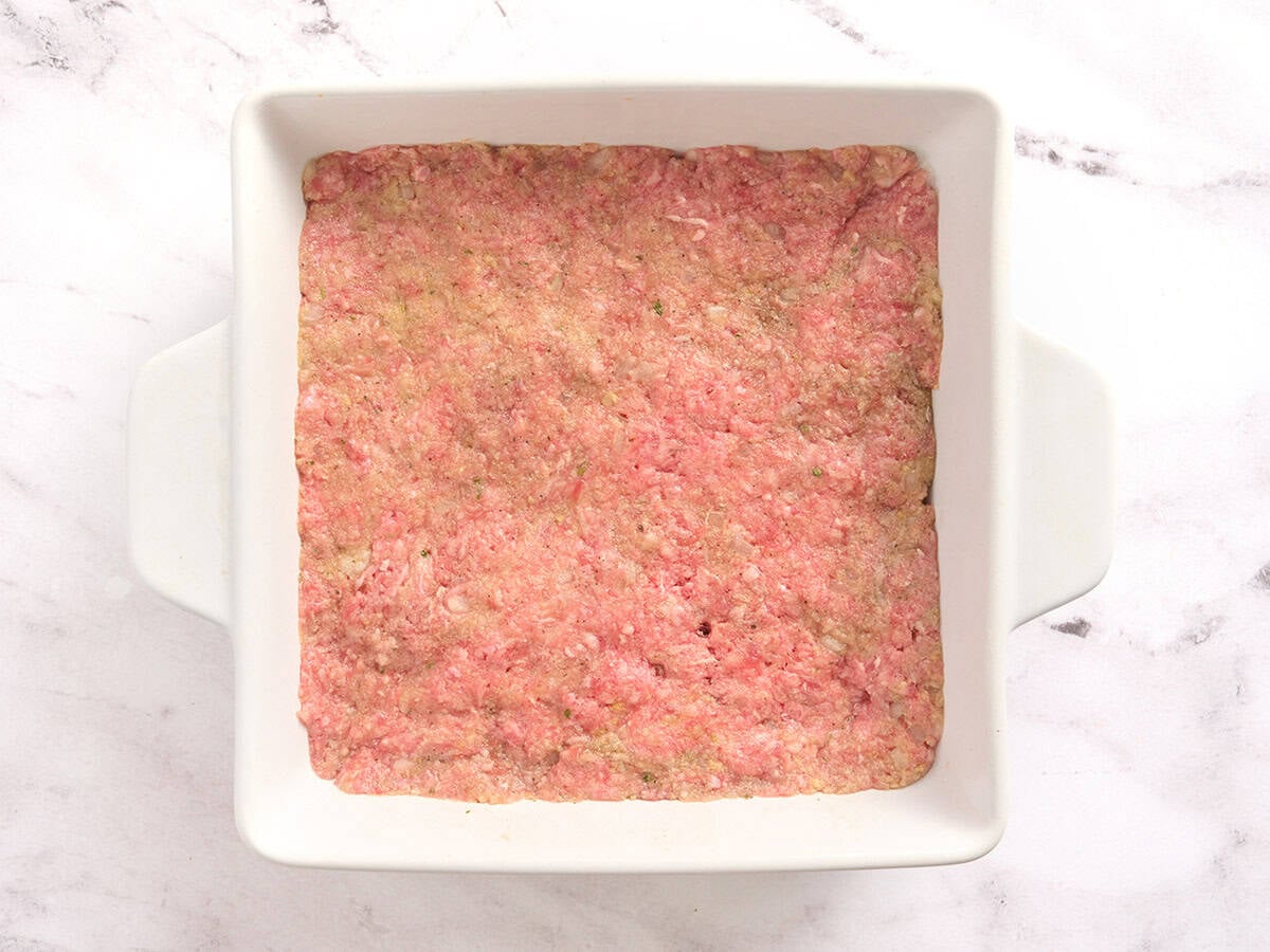 Meatloaf mixture in a square baking dish.