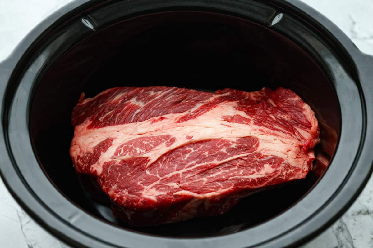 Chuck roast in the bottom of a crockpot.