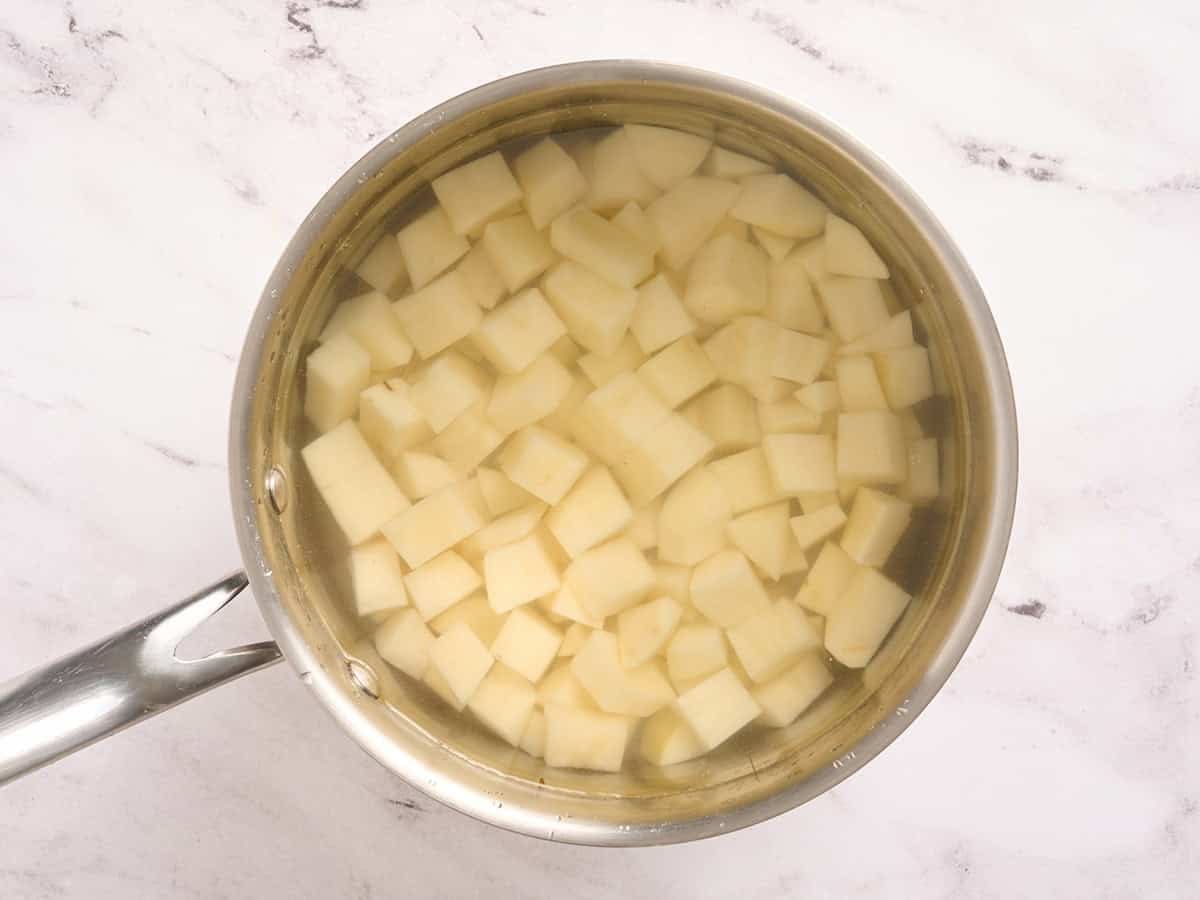 Diced potatoes in a pot of water.