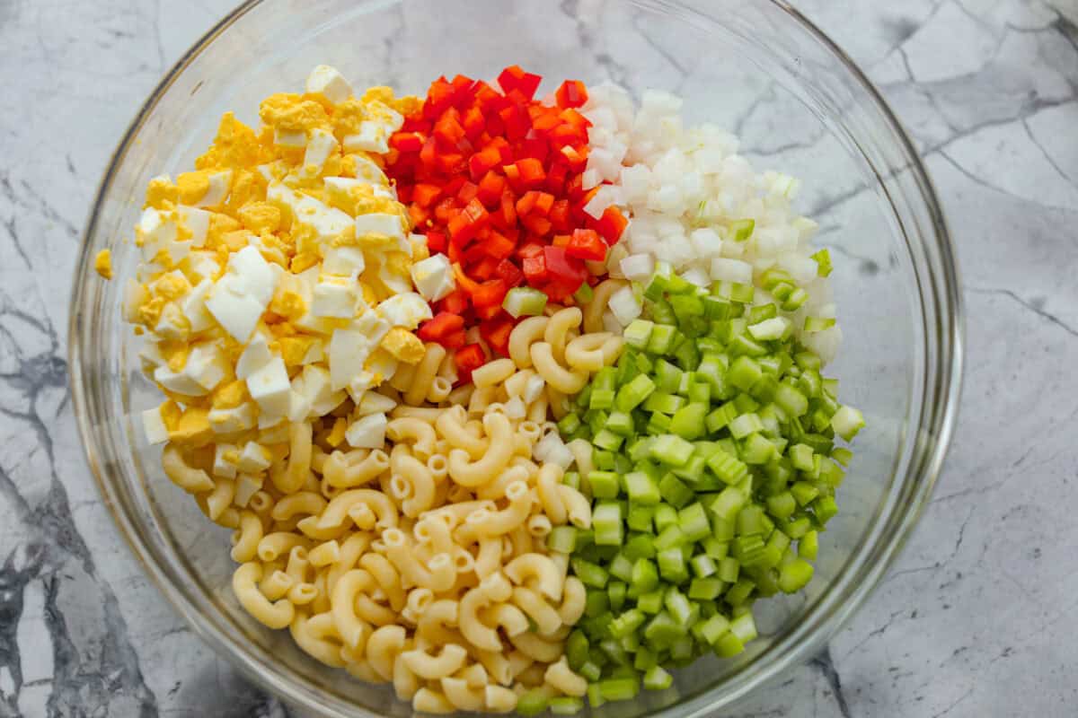 Bowl full of pasta salad ingredients.