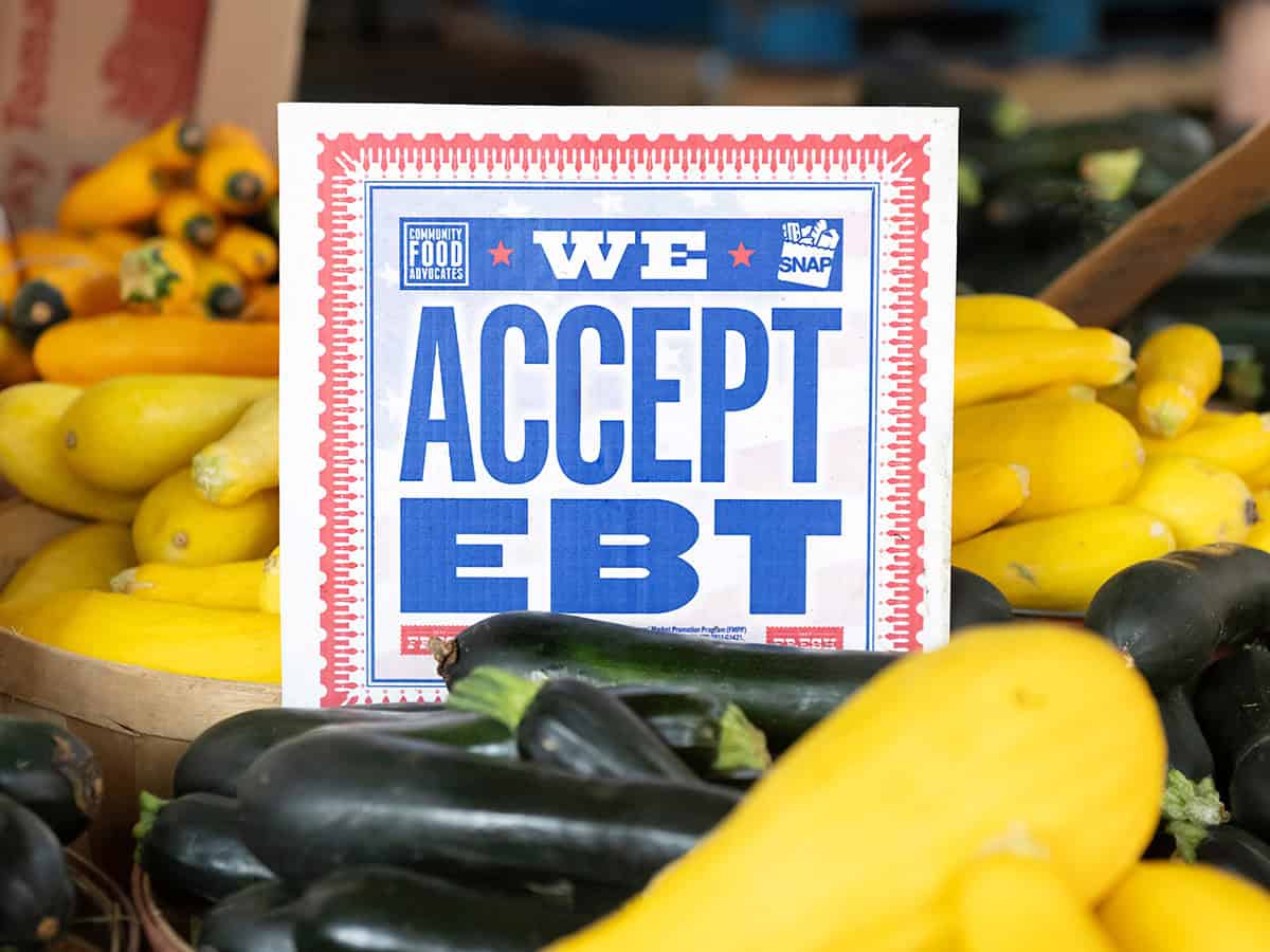 We accept EBT sign in a barrel of squash at farmer's market