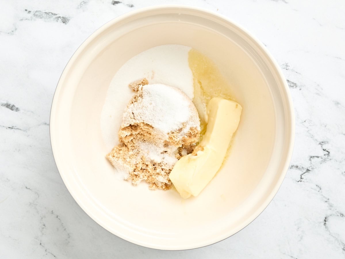 White and brown sugar in a bowl with butter.
