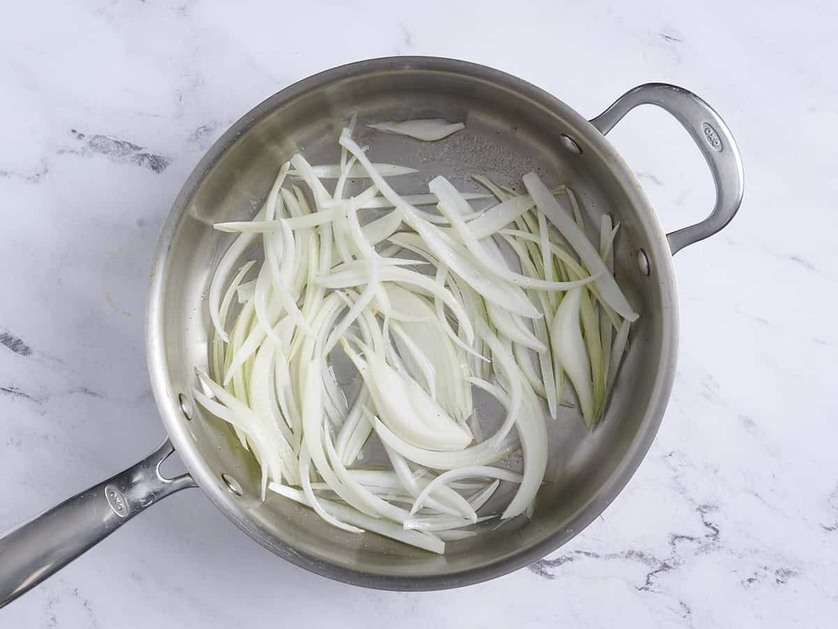 Sliced onions in a skillet.