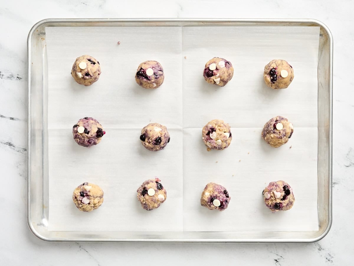 Balls of cookie dough on a baking sheet.