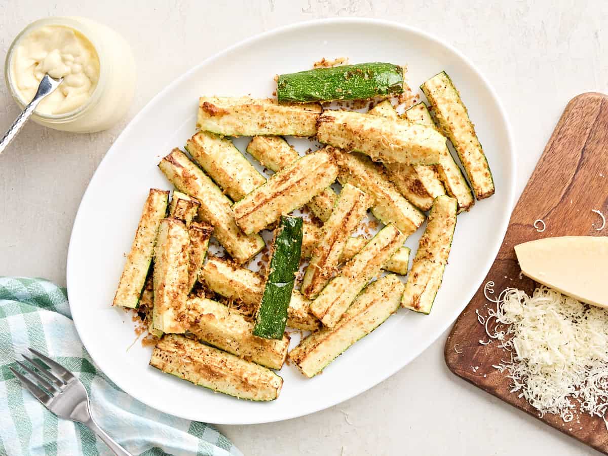 Overhead view of air fried zucchini on a plate.