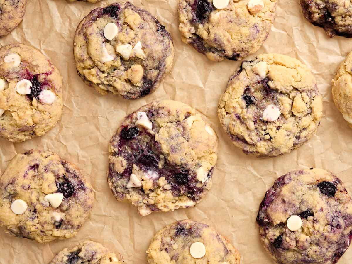 Overhead close up view of blueberry cookies on parchment paper.
