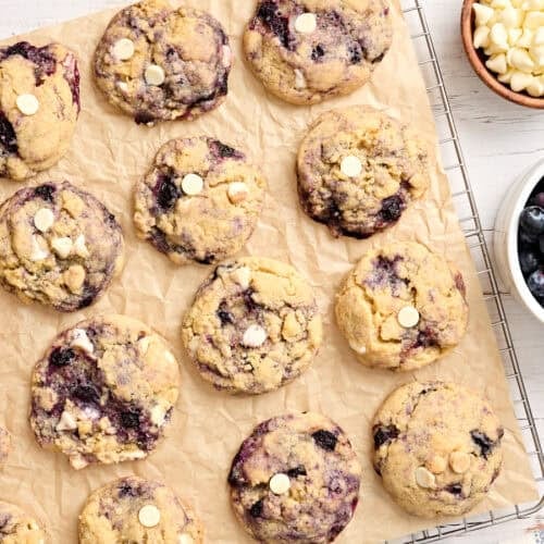 Overhead view of blueberry cookies on parchment paper.
