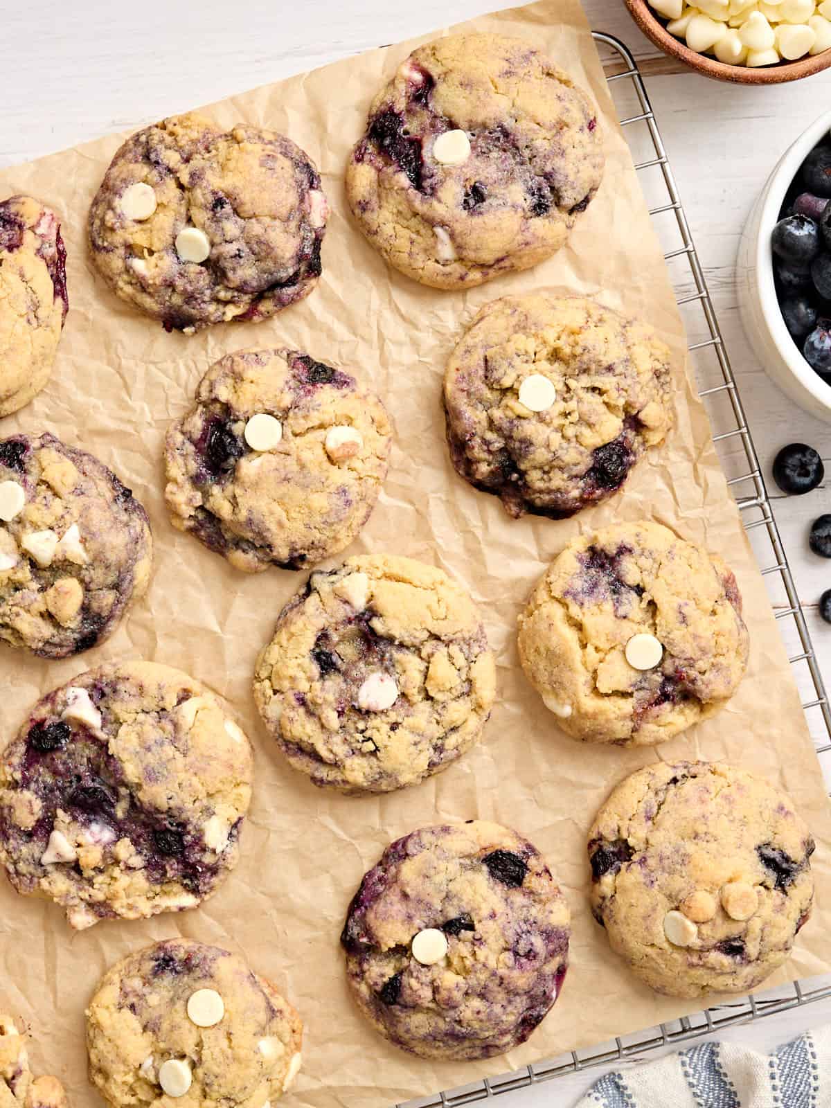 Overhead view of blueberry cookies on parchment paper.