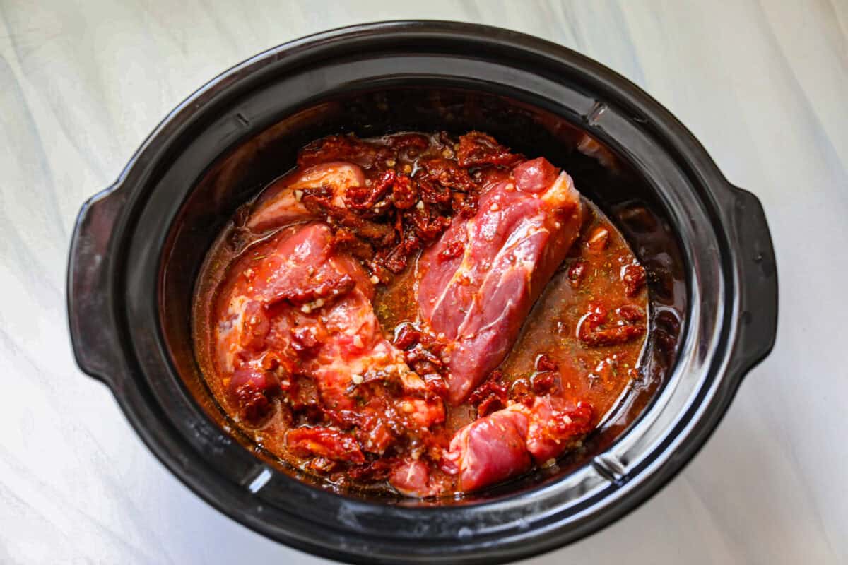 Pork plus the sauce in the slow cooker.