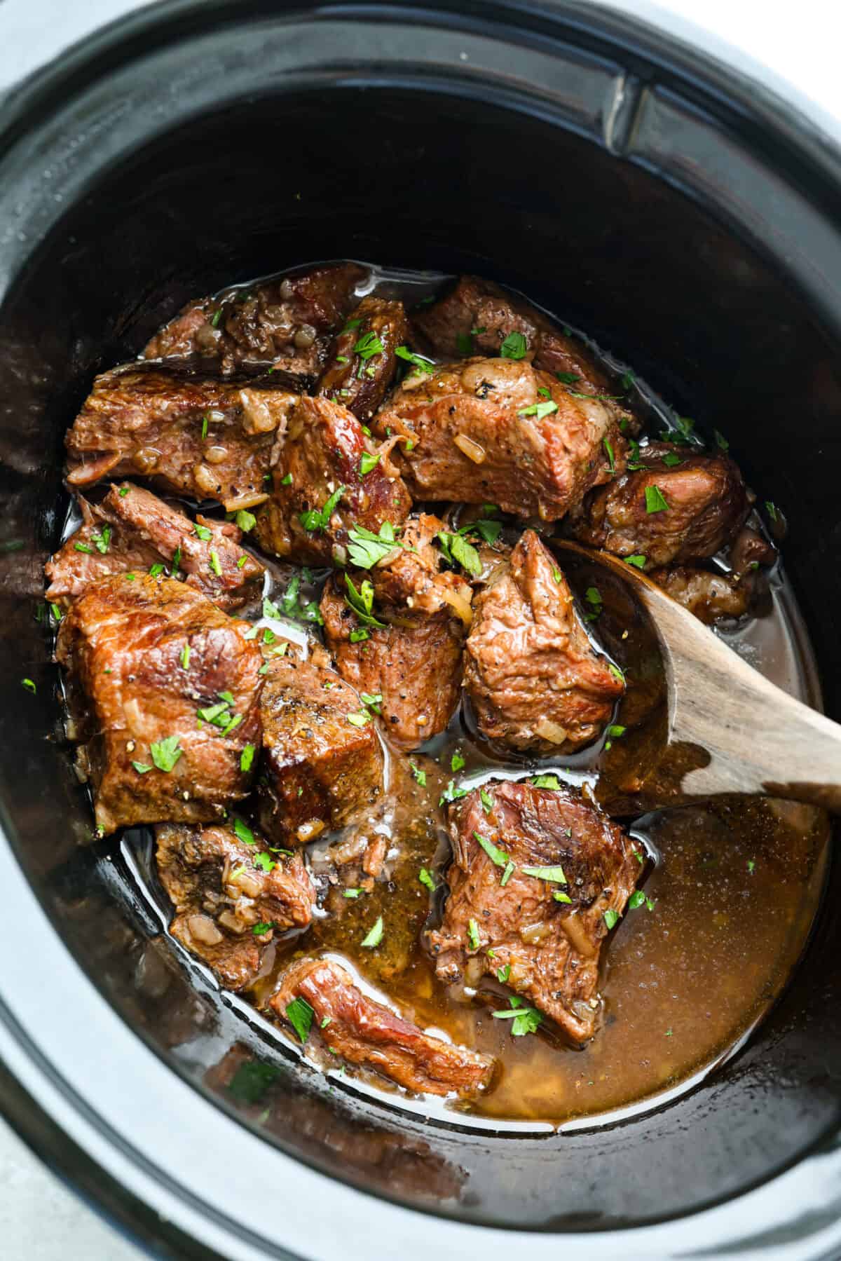Top down shot of cooked slow cooker 3 ingredient butter beef.