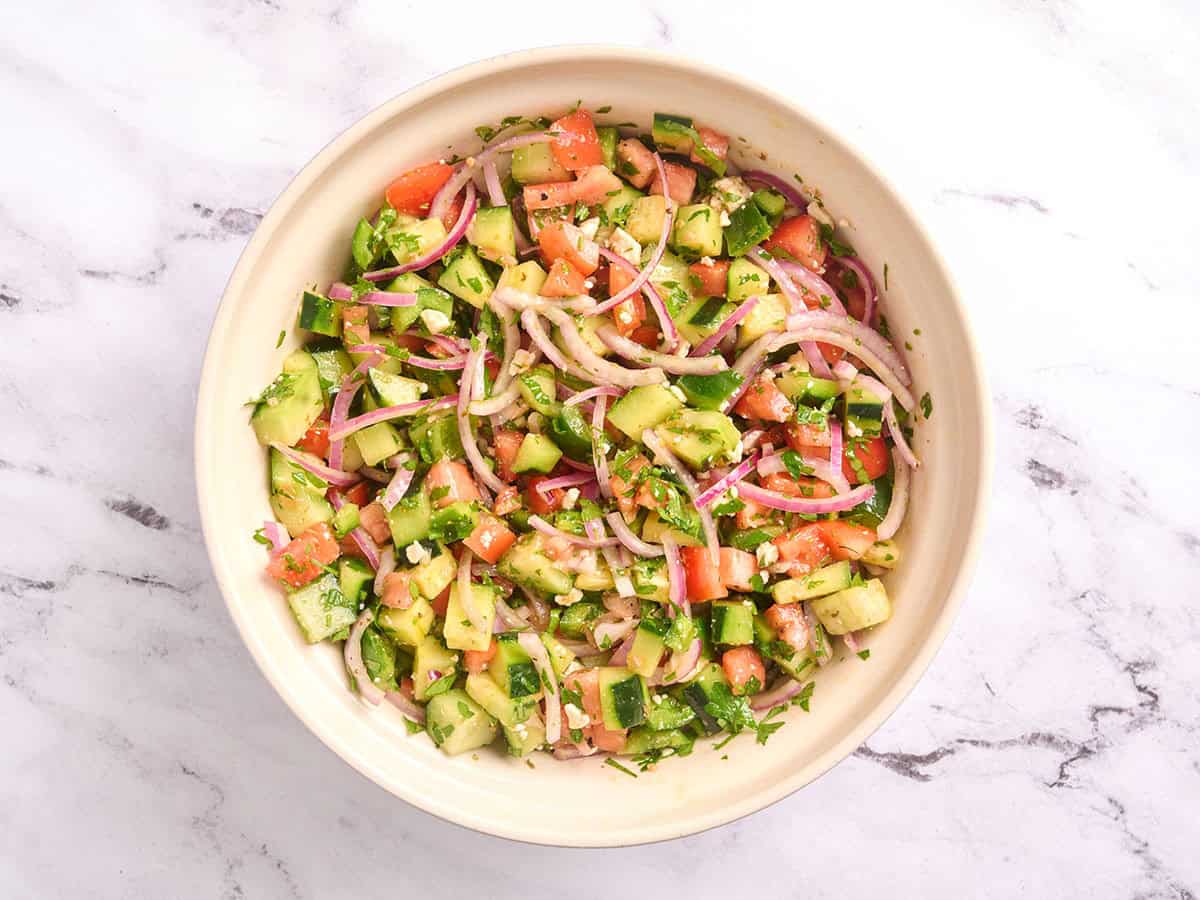A bowl of cucumber tomato salad.