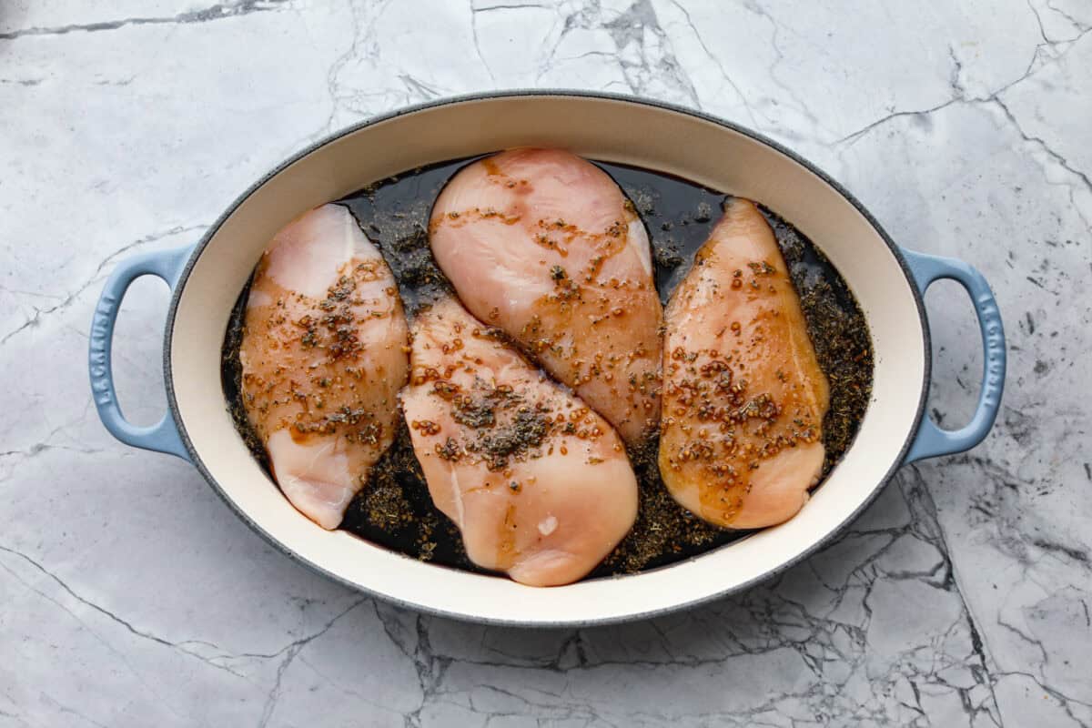 Juicy chicken, melty mozzarella, tomatoes, basil, and balsamic glaze all baked in one pan. Easy, fresh, and so good. Sauce poured over the toped of the chicken in the pan.