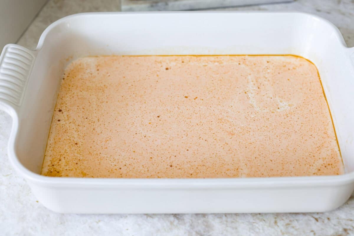 All of the sauce ingredients added to the bottom of the baking dish.