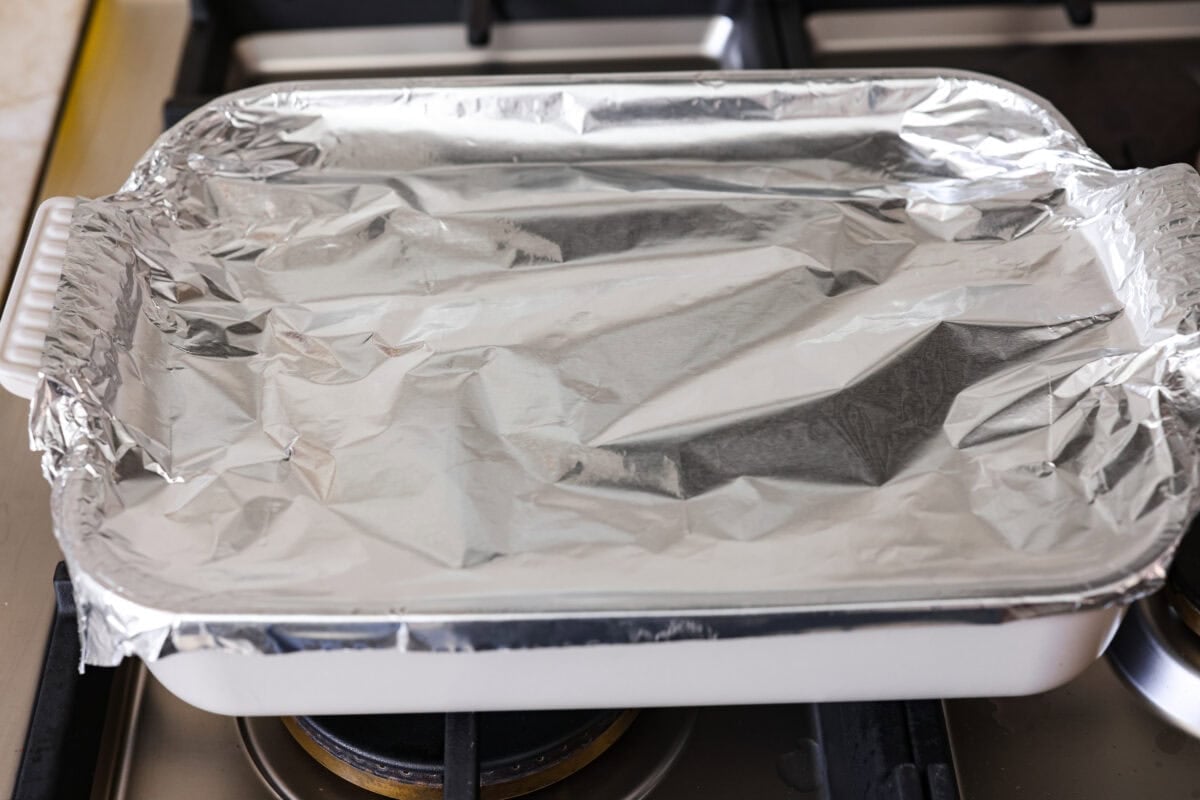Baking dish topped with tin foil ready to go in the oven.