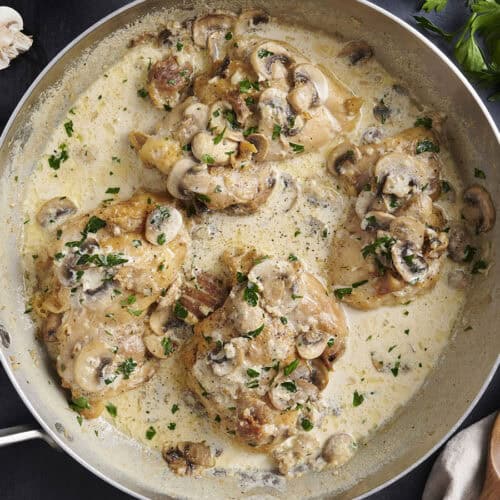 Overhead view of creamy mushroom chicken in a skillet.