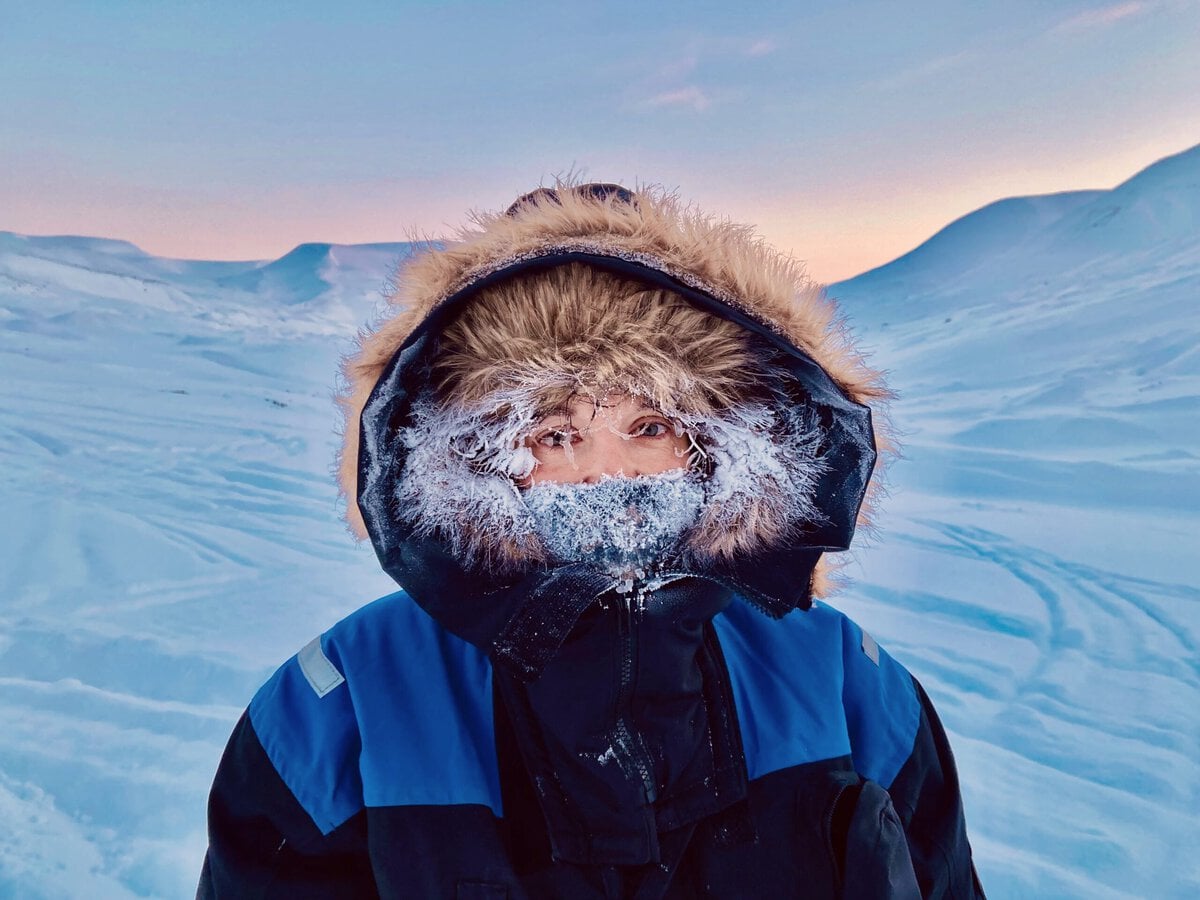 northern norway trip - A Guide to Exploring the Outdoors of Northern Norway Woman with a frozen hoodie in Svalbard