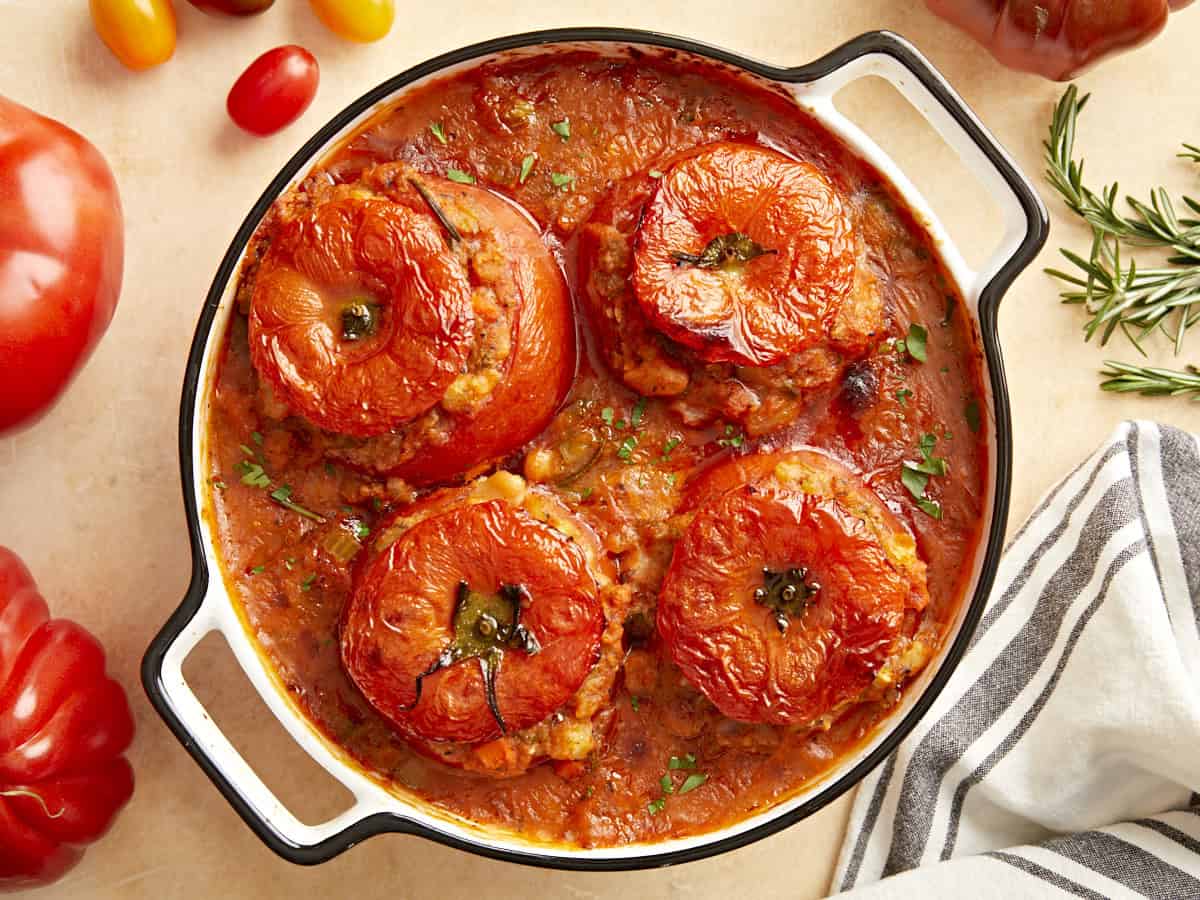 Overhead view of stuffed tomatoes with white beans.
