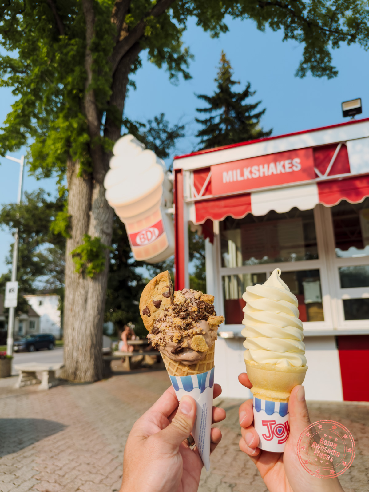 holding two ice cream cones from bdi in winnipeg